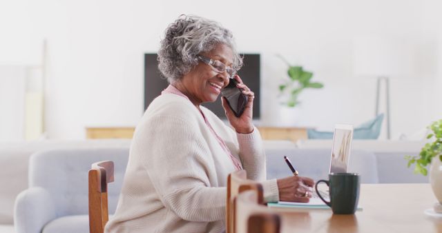 Senior Woman Working from Home Talking on Phone and Taking Notes - Download Free Stock Images Pikwizard.com