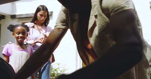 Family Preparing for Road Trip Together on Warm Day