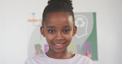 Confident African American Girl in Classroom with Educational Background