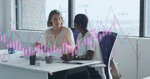Business Colleagues Analyzing Financial Data With Graph Overlay