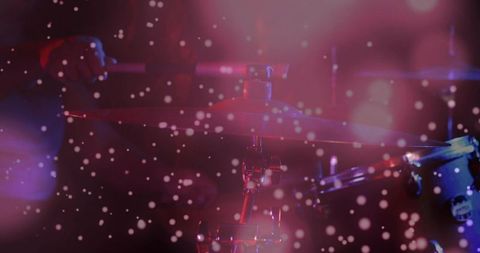 Shimmering cymbal reflecting magenta stage lights with chrome hardware and bokeh haze