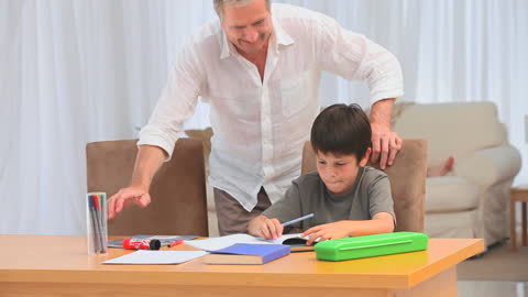 Father Helping Child with Homework at Home
