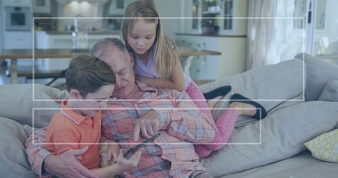 Happy Grandchildren and Grandparent Watching Smartphone Together at Home