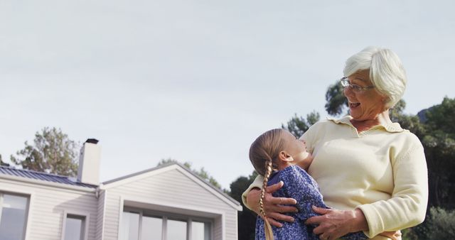 Grandmother Embracing Granddaughter Outside House in Countryside - Download Free Stock Images Pikwizard.com