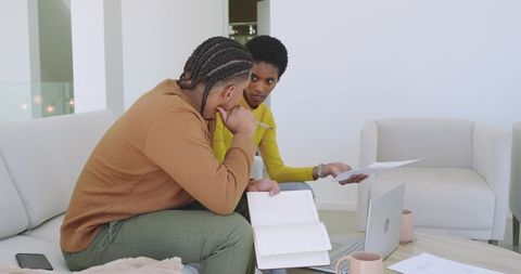 Diverse Professionals Collaborating on Business Project in Relaxed Workspace