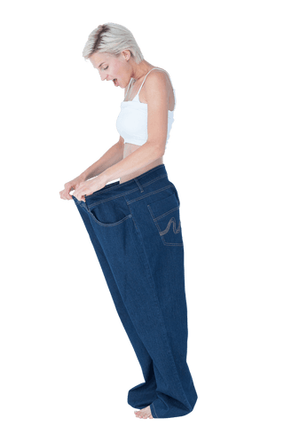 Surprised woman in transparent oversized pants isolated on white
