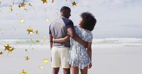 Couple Embracing by the Beach with Golden Stars Decor