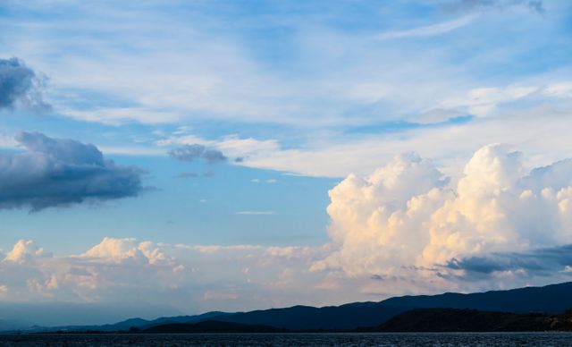Serene Coastal Landscape with Expansive Sky and Dramatic Clouds - Download Free Stock Photos Pikwizard.com