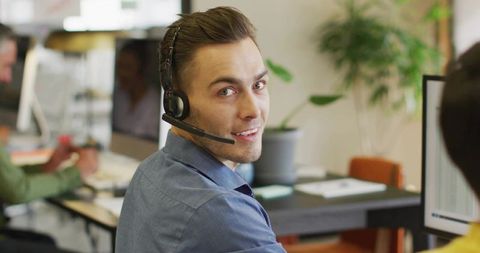 Customer Service Agent Wearing Headset in Modern Office Setting