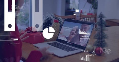Teen video calling grandparents on laptop during holiday with gifts and table decorations