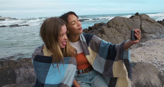 Youthful Friends Enjoying Selfie Moment on Rocky Beach - Download Free Stock Images Pikwizard.com