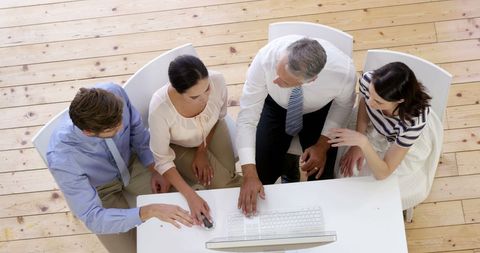 Diverse Business Team Collaborating on Project at Office Desk - Download Free Stock Images Pikwizard.com