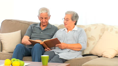 Senior Couple Relaxing on Sofa Together