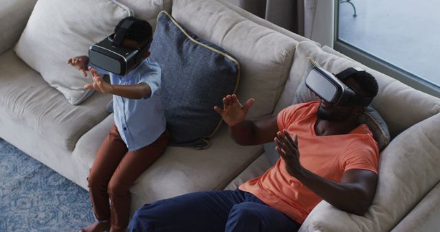 Father and Son Using VR Headsets on Couch - Download Free Stock Images Pikwizard.com