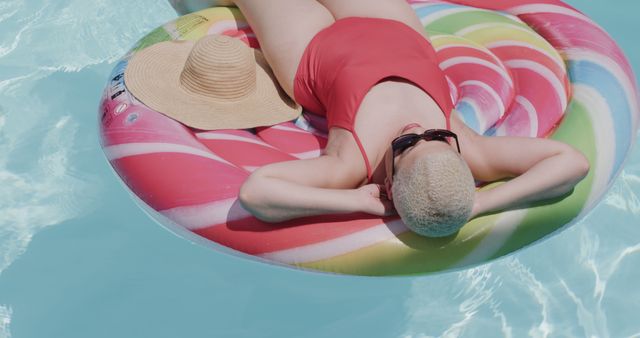 Woman Relaxing on Colorful Pool Float in Sun - Download Free Stock Images Pikwizard.com