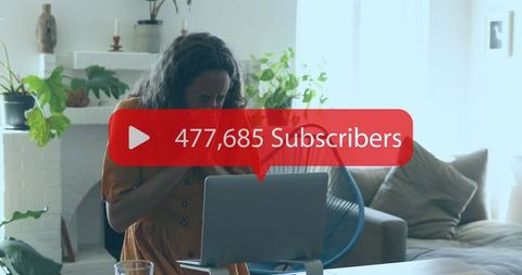 Joyful Woman Celebrates YouTube Milestone in Cozy Home Setting