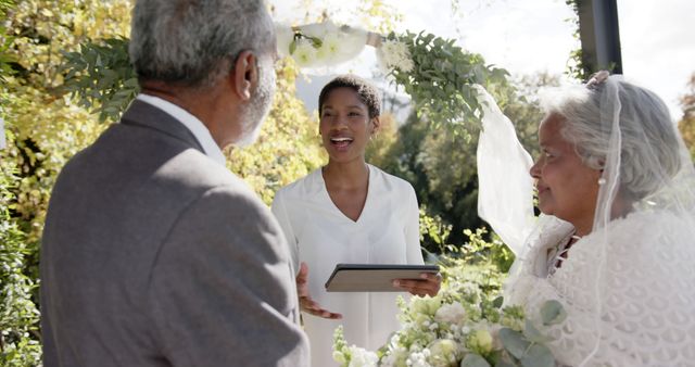 Joyful Wedding Officiant Celebrating Mature Couple in Outdoor Ceremony - Download Free Stock Images Pikwizard.com