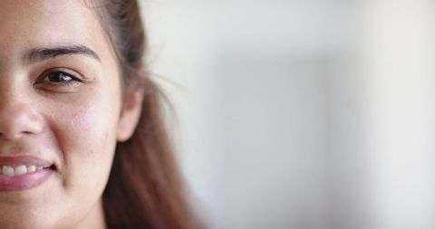 African american woman smiling and looking forward, freckled skin, soft natural light