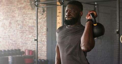 Man Lifting Kettlebell in Urban Gym Environment