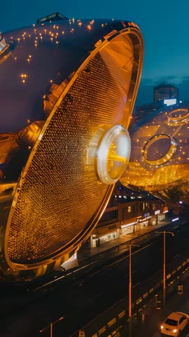 Vertical video glowing industrial reflector bulb illuminating urban street at dusk