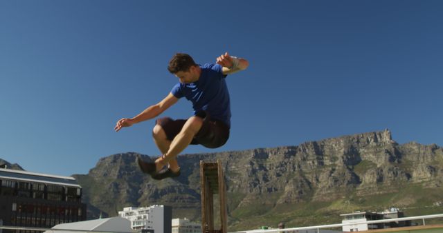 Man Jumping in Front of Mountain Range - Download Free Stock Images Pikwizard.com