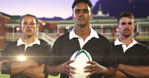 Confident Rugby Players Posed on a Field at Dusk
