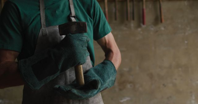 Male Blacksmith Holding Hammer in Workshop with Brick Wall - Download Free Stock Images Pikwizard.com