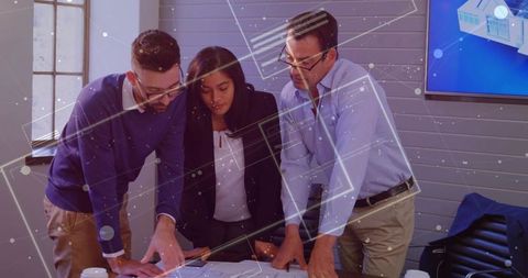 Business Team Analyzing Blueprints for Innovative Project