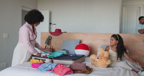 Mother Packing Suitcase with Daughter for Family Vacation Adventure