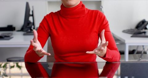 Businesswoman in Red Sweater Discussing at Modern Office