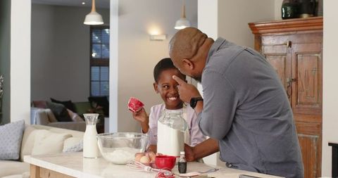 Father and Daughter Bonding in Kitchen While Baking Together