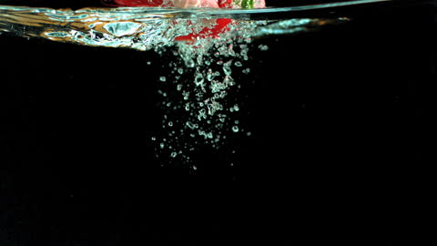 Red Bell Pepper Submerged in Clear Water with Striking Bubbles