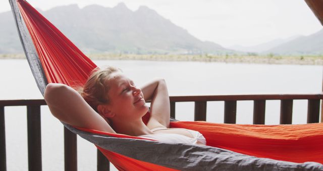 Female Reclining in Hammock by Lake with Mountain in Background - Download Free Stock Images Pikwizard.com