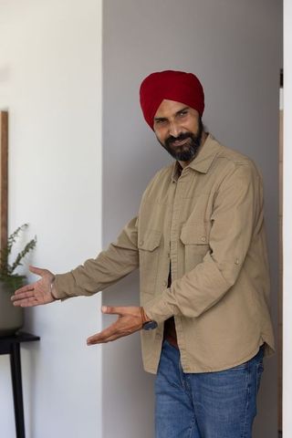 Middle-aged Man Presenting Indoor Plant, Welcoming Home Concept