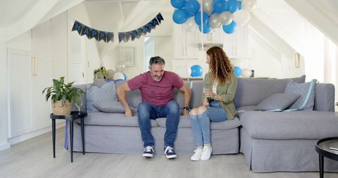 Happy Couple Celebrating Birthday with Decorations and Balloons