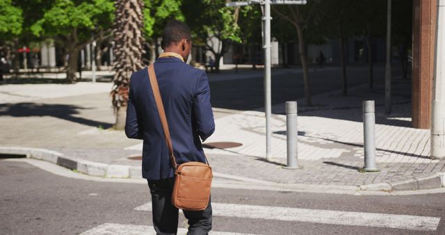 Businessman Walking Down Urban Street with Satchel Bag - Download Free Stock Images Pikwizard.com