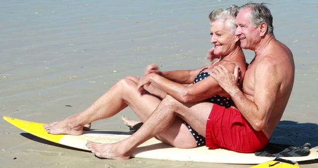 Happy Senior Couple Relaxing on Surfboard at Beach - Download Free Stock Images Pikwizard.com