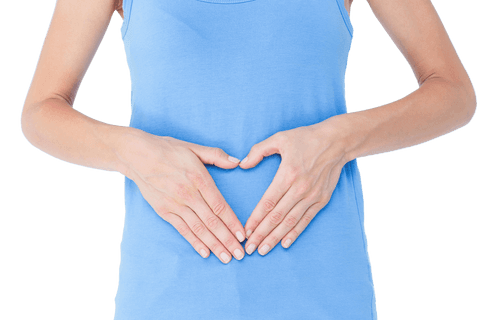 Woman in Blue Tank Top Showing Heart Gesture on Stomach