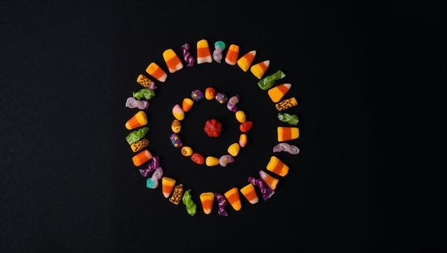 Geometric arrangement of halloween candy on dark background