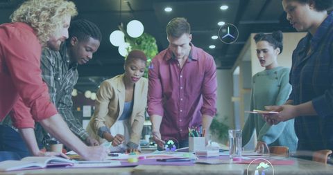 Diverse team collaborating on innovative product design in modern office