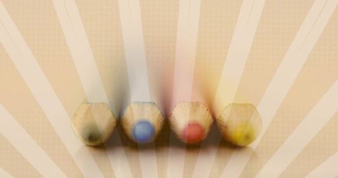 Muted vintage colored pencils lining sunburst background with green blue red yellow cores