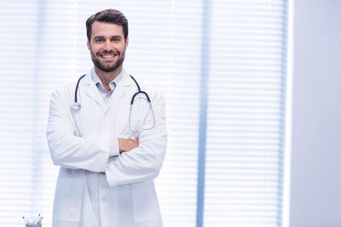 Confident Male Doctor Smiling in Modern Clinic with Stethoscope - Download Free Stock Images Pikwizard.com
