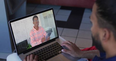 Man engaged in video conference on laptop for remote communication
