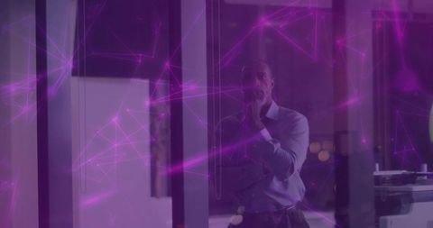 Businessman pondering future innovation in futuristic office setting