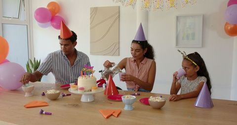 Family Celebrating a Birthday with Cake and Decorations