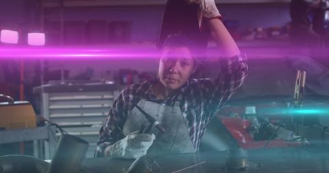 Female welder taking a break at workshop showing dedication and skill