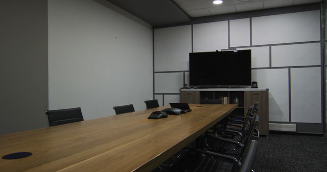 General view of empty conference room with television monitor, table and chairs in office. business and working in modern office.