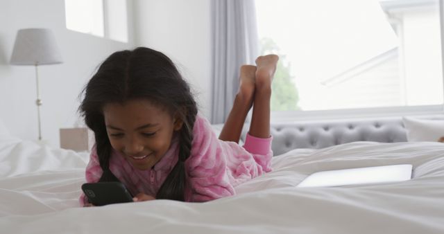 Happy Girl Using Smartphone While Lying on Bed - Download Free Stock Images Pikwizard.com