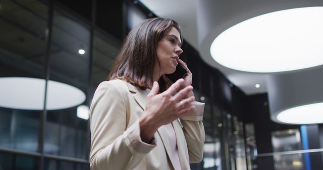 Businesswoman Talking on Phone in Modern Office Building at Night - Download Free Stock Images Pikwizard.com