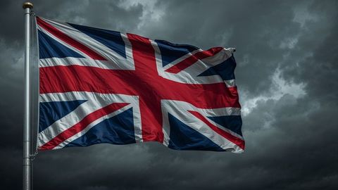 British empire flag fluttering against stormy sky